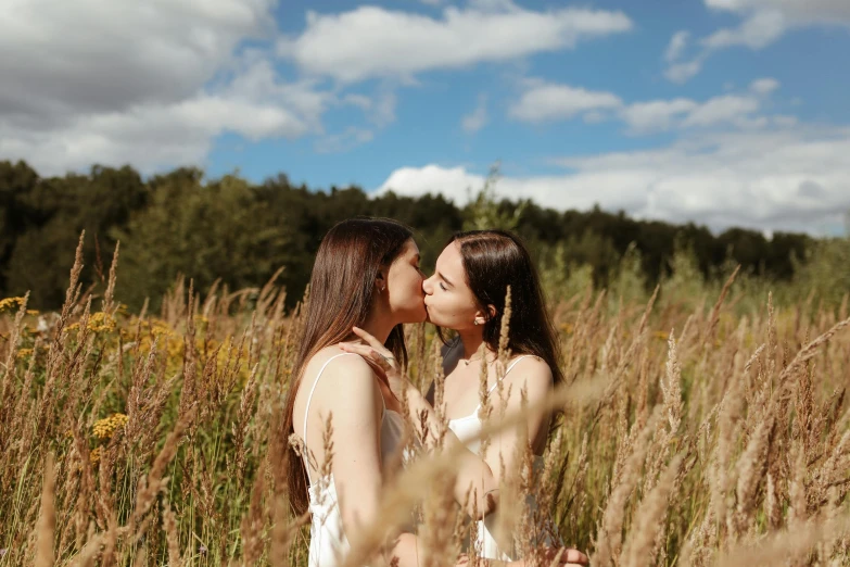 two women kissing in a field of tall grass, trending on pexels, brunettes, high quality product image”, queer woman, viewed from a distance