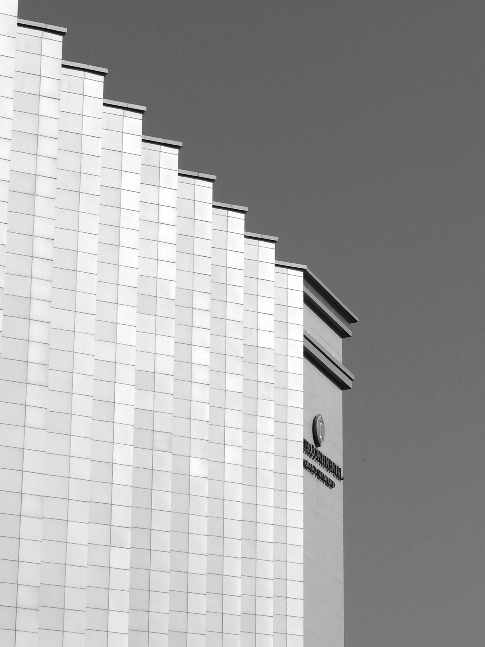 a black and white photo of a tall building, by Christopher Williams, wall corner, white monochrome color!!!!!, rounded roof, pixel perfect photograph