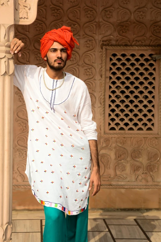 a man in a turban poses for a picture, featured on reddit, loose - fitting blouses, promotional image, square, tunic