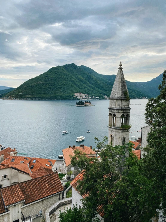 a view of a town next to a body of water, by Julia Pishtar, pexels contest winner, renaissance, boka, lush surroundings, panoramic view, to