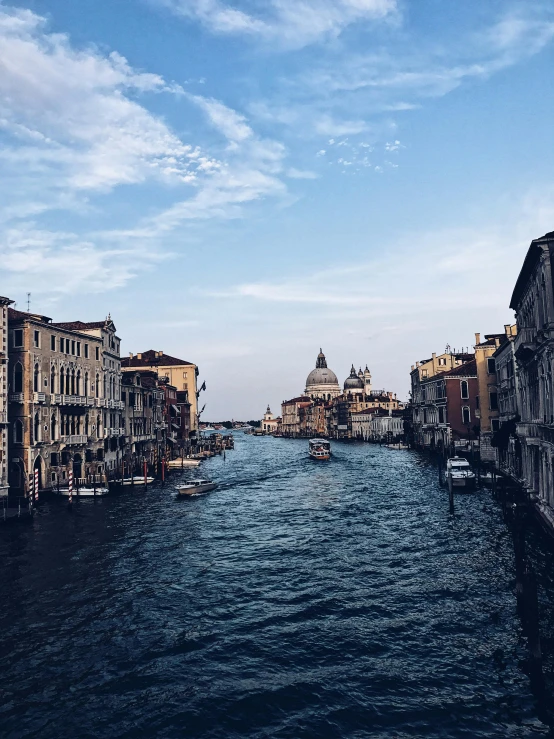 a river running through a city next to tall buildings, pexels contest winner, renaissance, venice biennale's golden lion, 💋 💄 👠 👗, dark academia aesthetics, looking towards camera