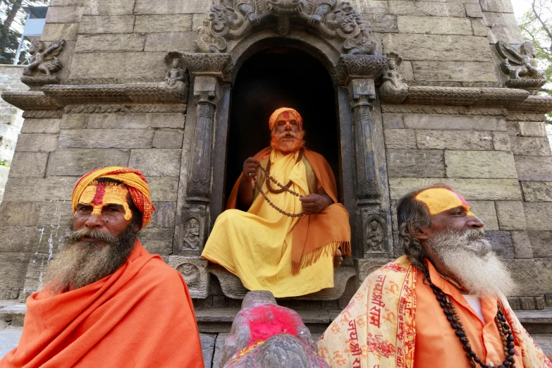 a couple of men sitting next to each other, samikshavad, orange robe, the three moiras, sacred ancient architecture, slide show