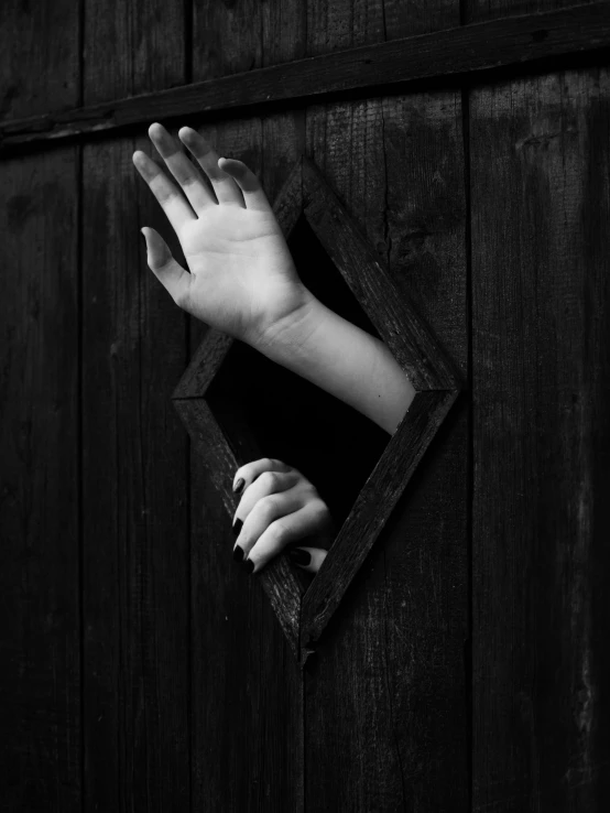 a hand sticking out of a hole in a wooden wall, by andrei riabovitchev, mysterious woman, by joseph binder, black an white, paul barson