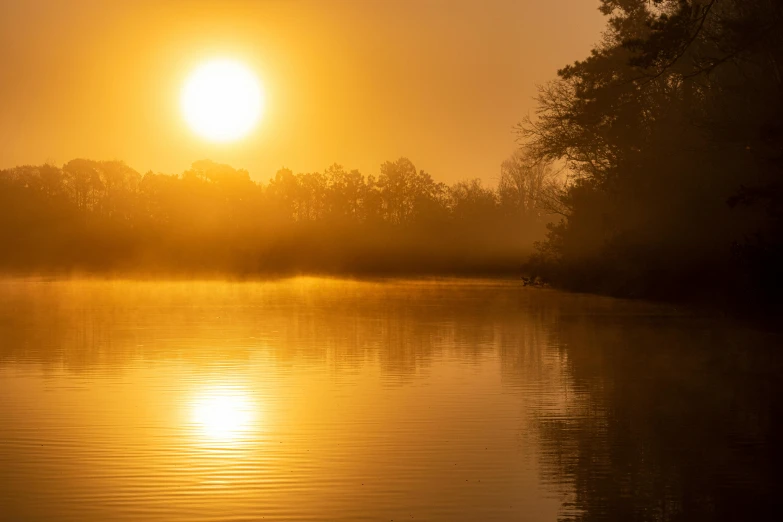 the sun is setting over a body of water, by Eglon van der Neer, pexels contest winner, romanticism, yellow mist, bayou, light orange mist, today's featured photograph 4k