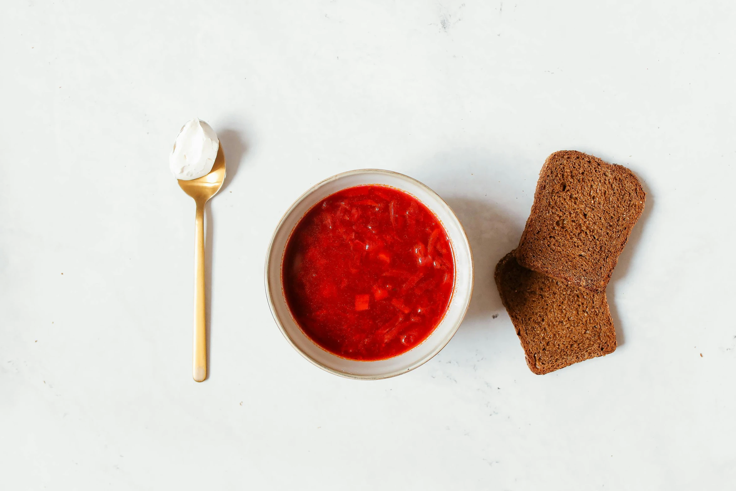 a bowl of soup with a spoon next to it, unsplash, dau-al-set, plate of borscht, white bg, high grain, coral red