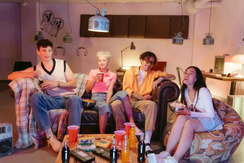a group of people sitting on top of a couch, pexels, declan mckenna, 8 0 s asian neon movie still, cottagecore hippie, shaven