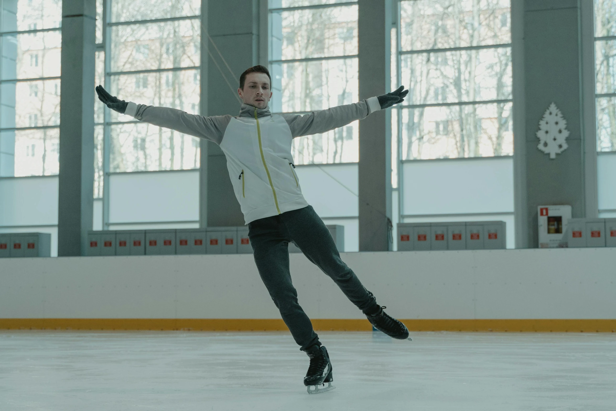 a man riding a skateboard on top of an ice rink, inspired by Andrei Ryabushkin, arabesque, **cinematic, thumbnail, pose 4 of 1 6, shot on nicon camera