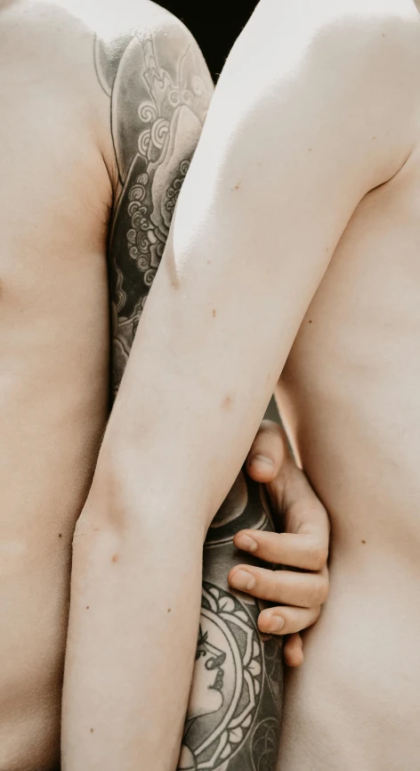 a couple of men standing next to each other, a tattoo, trending on pexels, massurrealism, lesbian embrace, human skin texture, multiple arms, porcelain pale skin