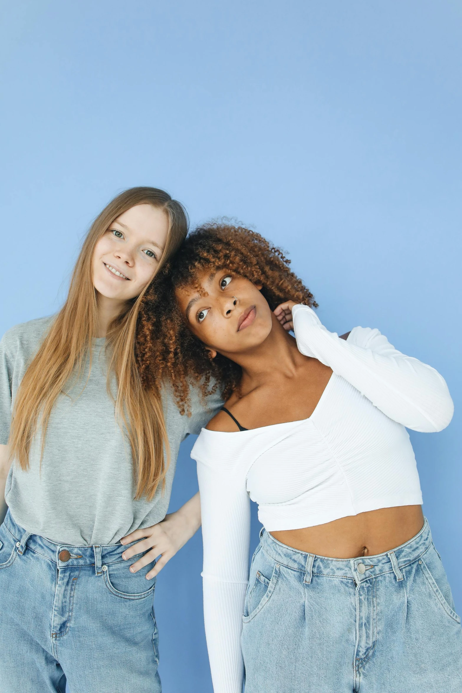 two young women standing next to each other, trending on pexels, renaissance, varying ethnicities, light blue skin, wearing a crop top, teenager girl