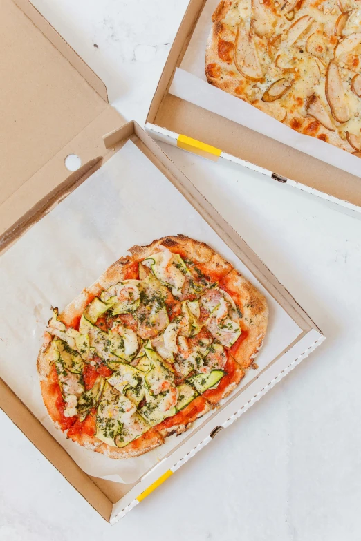 two boxes of pizza sitting on top of a table, inspired by Michelangelo Buonarotti, unsplash, on a pale background, opening, greens), various sizes