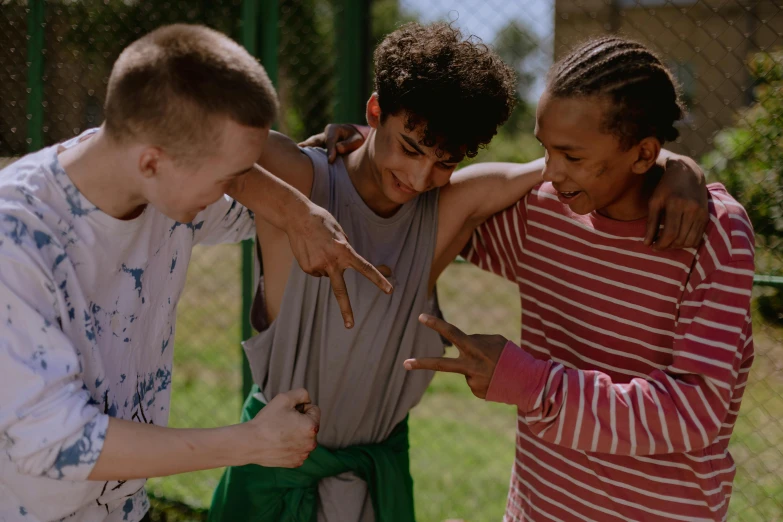 a group of young men standing next to each other, by Emma Andijewska, pexels contest winner, happening, kids playing, pointing, still from the movie, black teenage boy