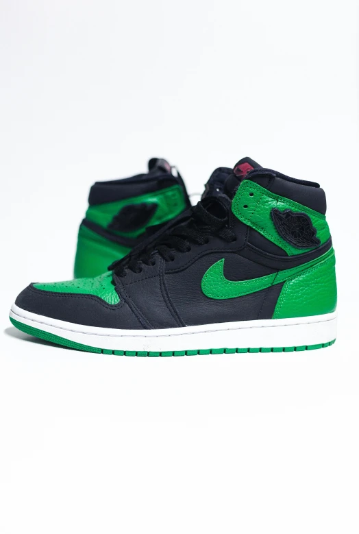a pair of green and black sneakers on a white surface, an album cover, by Paul Bird, unsplash, air jordan 1 high, vivid green lasers, green bright red, high detailed