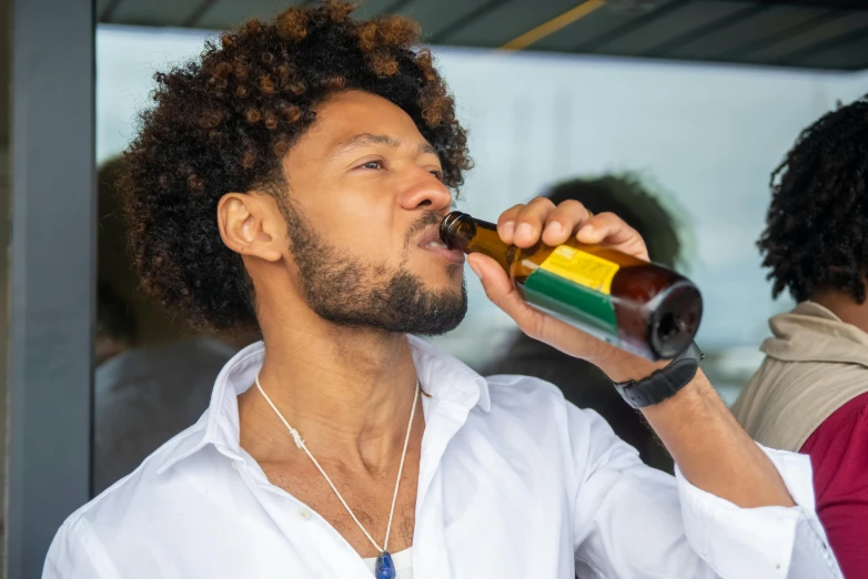 a man in a white shirt drinking from a bottle, pexels contest winner, renaissance, with afro, beer, a handsome, reggae