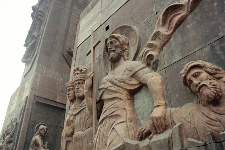 a group of statues on the side of a building, by Arthur Sarkissian, pexels contest winner, massive arch, martyrdom, promo image, in front of a carved screen