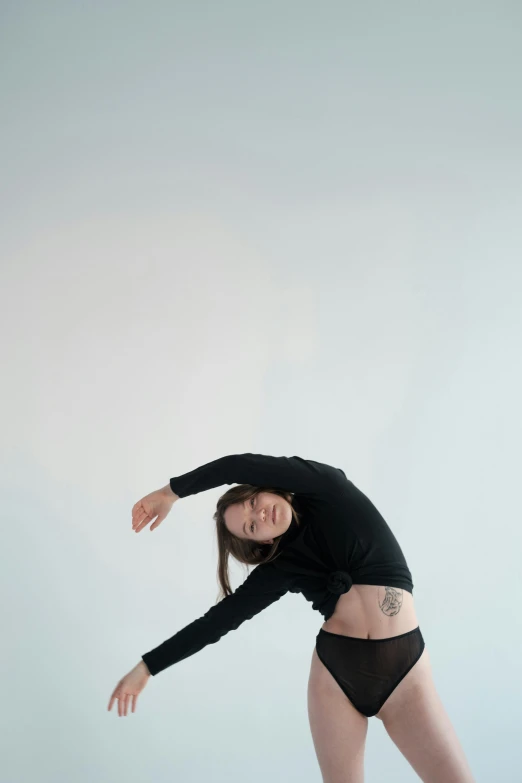 a woman in a black leo leo leo leo leo leo leo leo leo leo leo leo leo, an album cover, inspired by Elizabeth Polunin, unsplash, default pose neutral expression, bend over posture, tattooed, gif