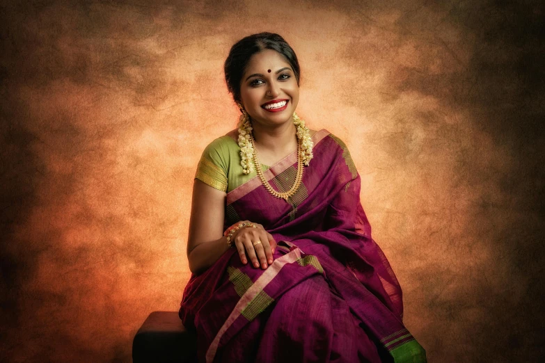 a woman in a purple sari sitting on a stool, a portrait, by Meredith Dillman, pexels contest winner, dramatic smile pose intricate, archan nair, wearing elegant jewellery, draped in fleshy green and pink