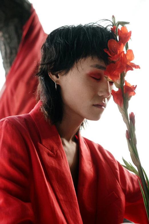 a woman in a red robe holding a flower, an album cover, inspired by Chen Chi, trending on pexels, androgyny, profile pic, ashteroth, indonesia