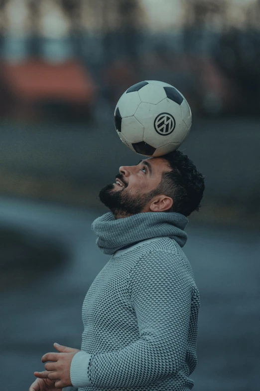 a man balancing a soccer ball on his head, pexels contest winner, very attractive man with beard, gif, gray men, square