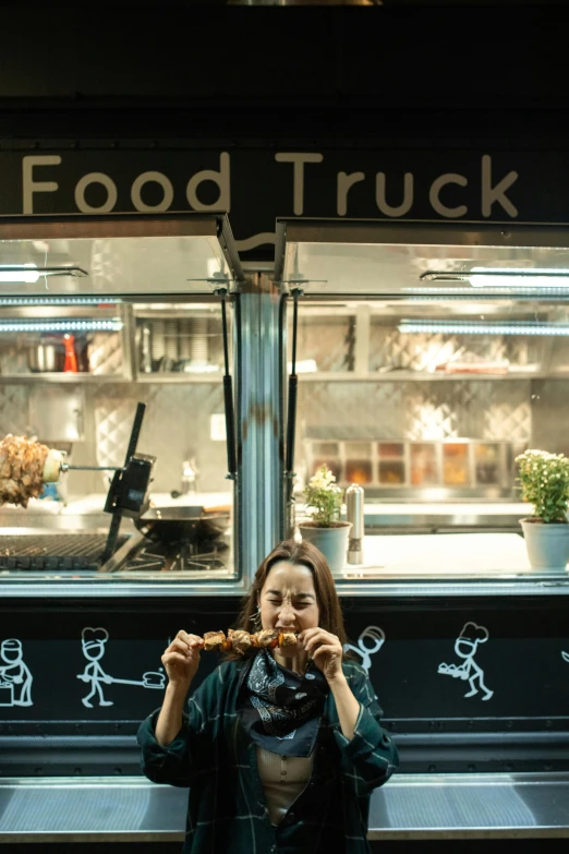 a woman sitting on a bench in front of a food truck, in front of a black background, square, truck, fork fork