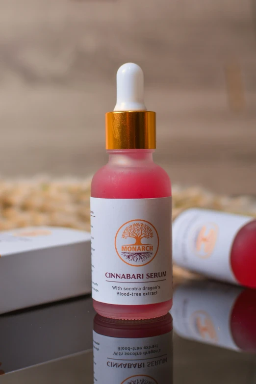 a close up of a bottle of liquid on a table, product image, cinnabar, pink skin, hemp