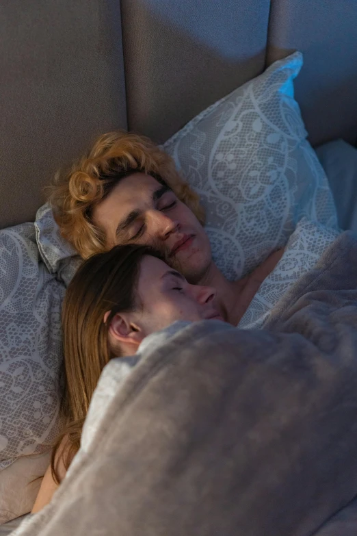 a man and woman laying in bed next to each other, inspired by Nan Goldin, trending on reddit, renaissance, robert sheehan, pale skin curly blond hair, scene from live action movie, profile image