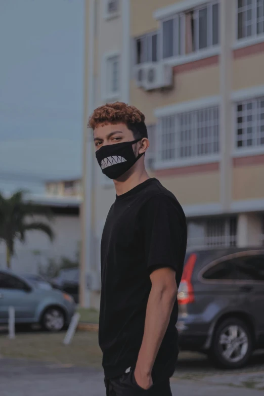 a man standing in a parking lot wearing a face mask, by Adam Rex, reddit, puerto rico, star wars inspired, teenage, promo image
