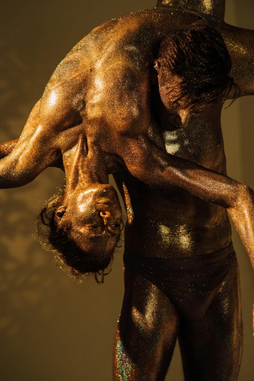 a statue of a man holding a woman on his back, by Jan Tengnagel, pexels contest winner, australian tonalism, brown skin like soil, vivid studio light, performance art, saint homo neanderthalis