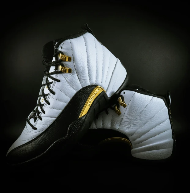 a pair of air jordans on a black background, pexels contest winner, white and gold dress, fan favorite, 3/4 view from below, trecking