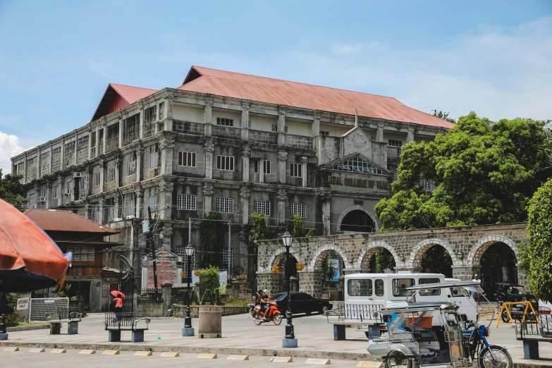 a group of motorcycles parked in front of a building, inspired by Maties Palau Ferré, pexels contest winner, renaissance, philippines, square, seen from afar, preserved historical