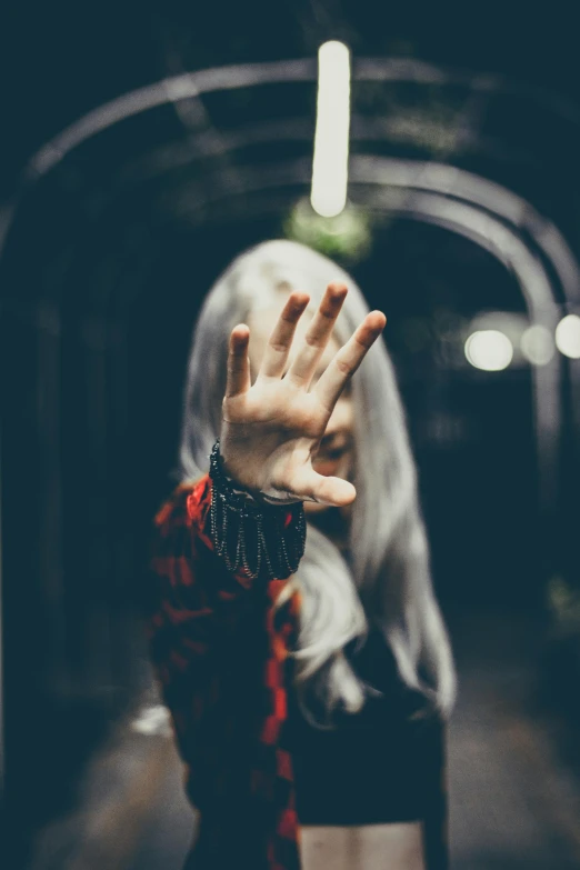 a woman with long white hair standing in a tunnel, inspired by Elsa Bleda, unsplash, hand with five fingers, yoko taro, indistinct man with his hand up, profile image