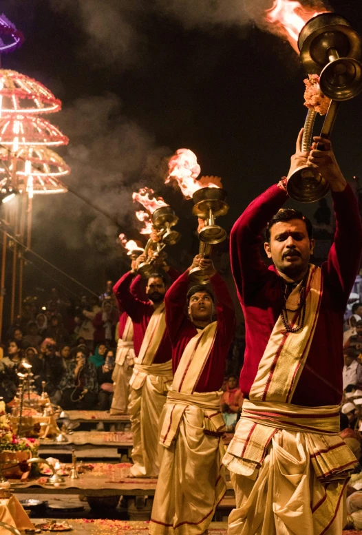 a group of men standing on top of a stage, pexels contest winner, samikshavad, flaming torches and pitchforks, kalighat, square, deity)