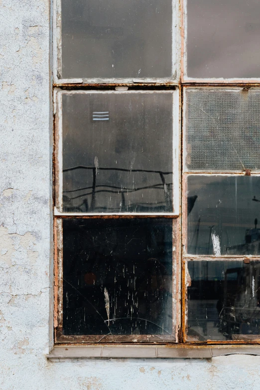 a fire hydrant sitting in front of a window, inspired by Elsa Bleda, trending on unsplash, modernism, old lumber mill remains, black windows, abstract mirrors, buildings covered in black tar