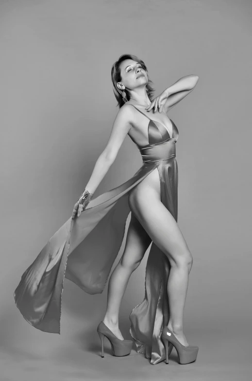 a black and white photo of a woman in a dress, an album cover, inspired by Richard Avedon, arabesque, emma watson wearing a swimsuit, satin silver, full body cgsociety, low cut dress