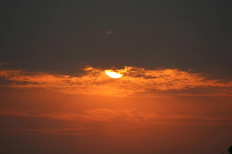 the sun is setting behind the clouds in the sky, a picture, golden hour photograph, trending photo, uncropped, shot on 1 5 0 mm