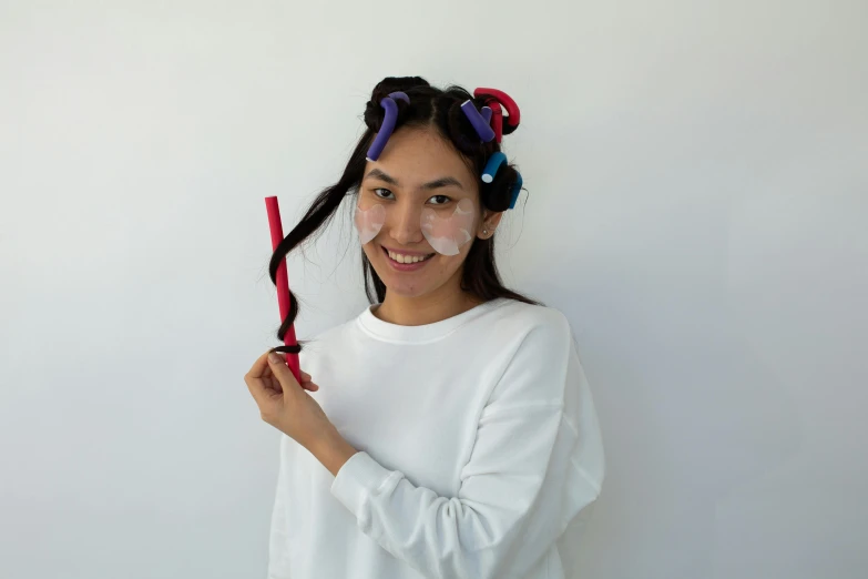 a woman in curlers holding a pair of scissors, inspired by Kim Jeong-hui, gutai group, no makeup wavy hair, detailed product image, wearing a headband, multi - coloured