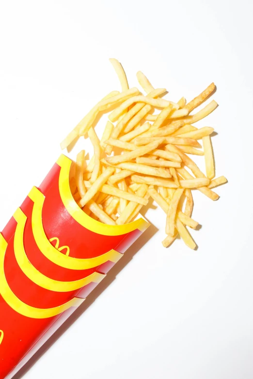 a red tube with french fries sticking out of it, mcdonald, jen atkin, f / 1, shredded