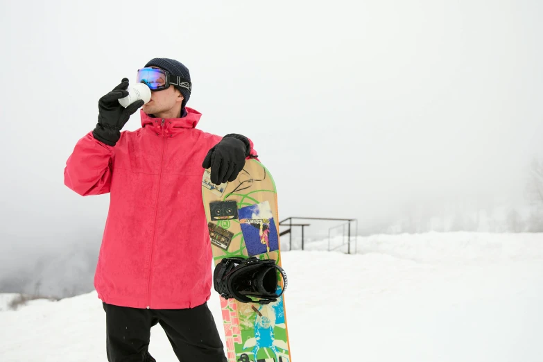 a man standing in the snow holding a snowboard, goggles on forehead, tech robes, avatar image, sports photo