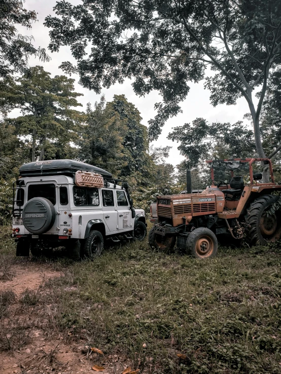 two vehicles parked next to each other on a dirt road, by Tony Szczudlo, sumatraism, deep in the woods, mechanised, on top of it, profile image