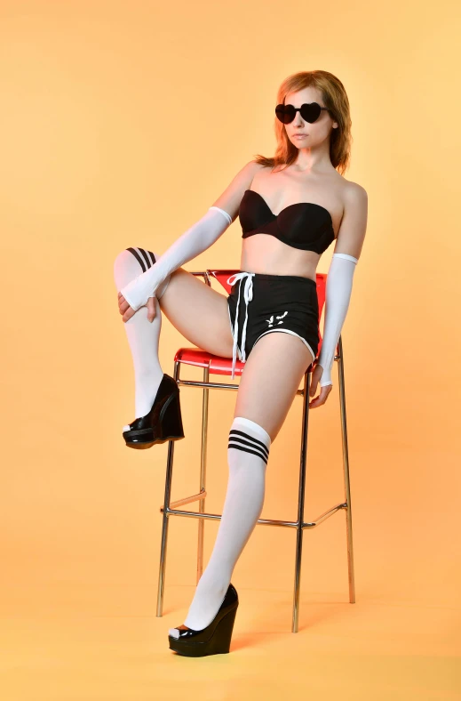 a woman sitting on top of a red chair, inspired by Gil Elvgren, dada, wearing kneesocks, bra and shorts streetwear, 15081959 21121991 01012000 4k, cosplay photo