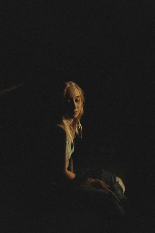 a woman sitting on the ground in the dark, an album cover, inspired by Elsa Bleda, sydney sweeney, portrait soft low light, sophie turner, gif