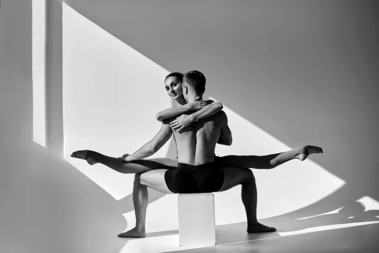 a man and a woman doing a yoga pose, a black and white photo, by Maurycy Gottlieb, saatchi art, photography alexey kurylev, two men hugging, eero aarnio