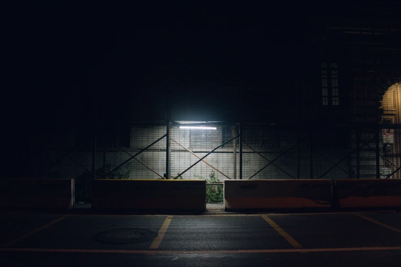 a car parked in a parking lot at night, inspired by Elsa Bleda, barriers, dark warehouse, masami suda, streetlight