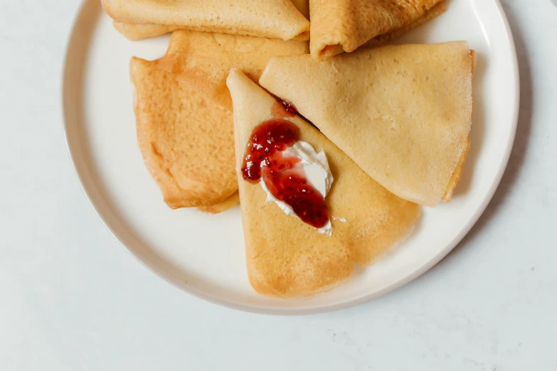 a plate that has some food on it, an album cover, by Emma Andijewska, unsplash, renaissance, manta ray made of pancake, reds, cone shaped, russian