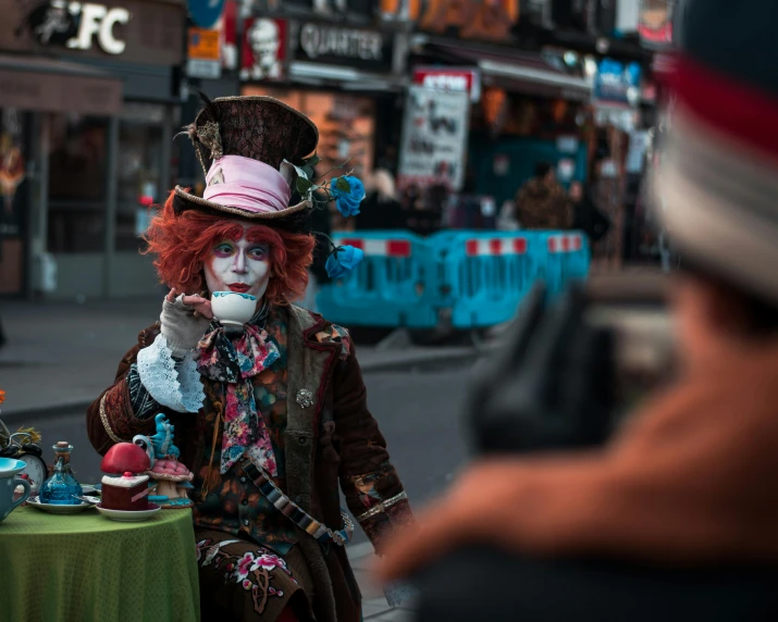 a man dressed up as a mad hatter on a street corner, a photo, pexels contest winner, square, cheshire cat drinking tea, post-apocalyptic times square, youtube thumbnail