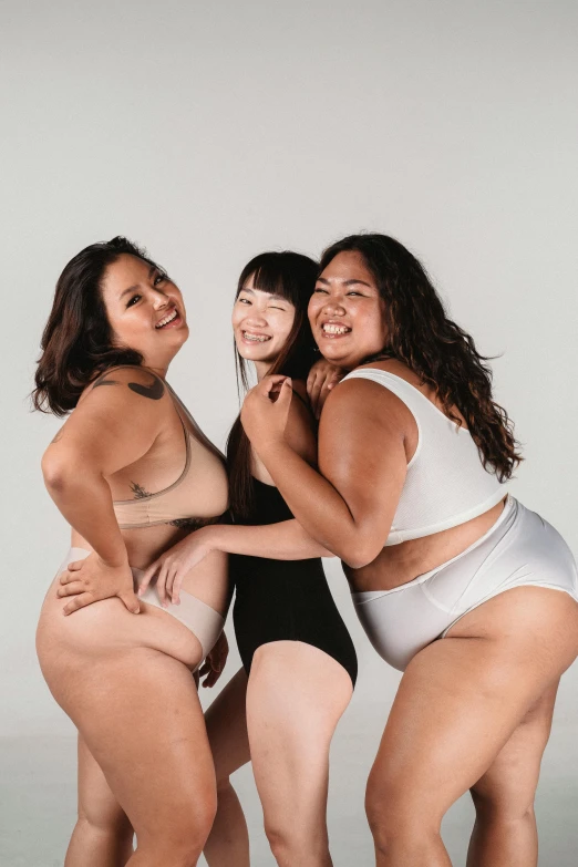 a group of three women standing next to each other, unsplash, big stomach, silicone skin, joy ang, with a white background