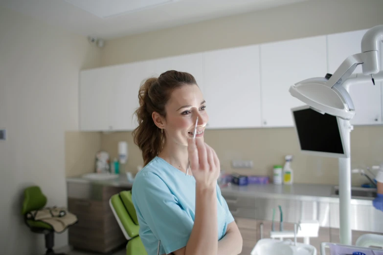 a woman is smiling in a dentist's office, a picture, by Adam Marczyński, pexels contest winner, happening, hand over mouth, profile image, thumbnail, 15081959 21121991 01012000 4k