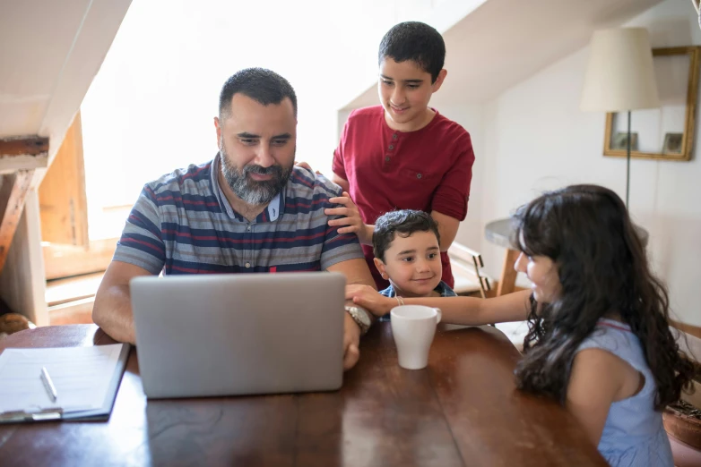 a man sitting at a table with two children and a laptop, profile image, middle eastern, thumbnail, regular build