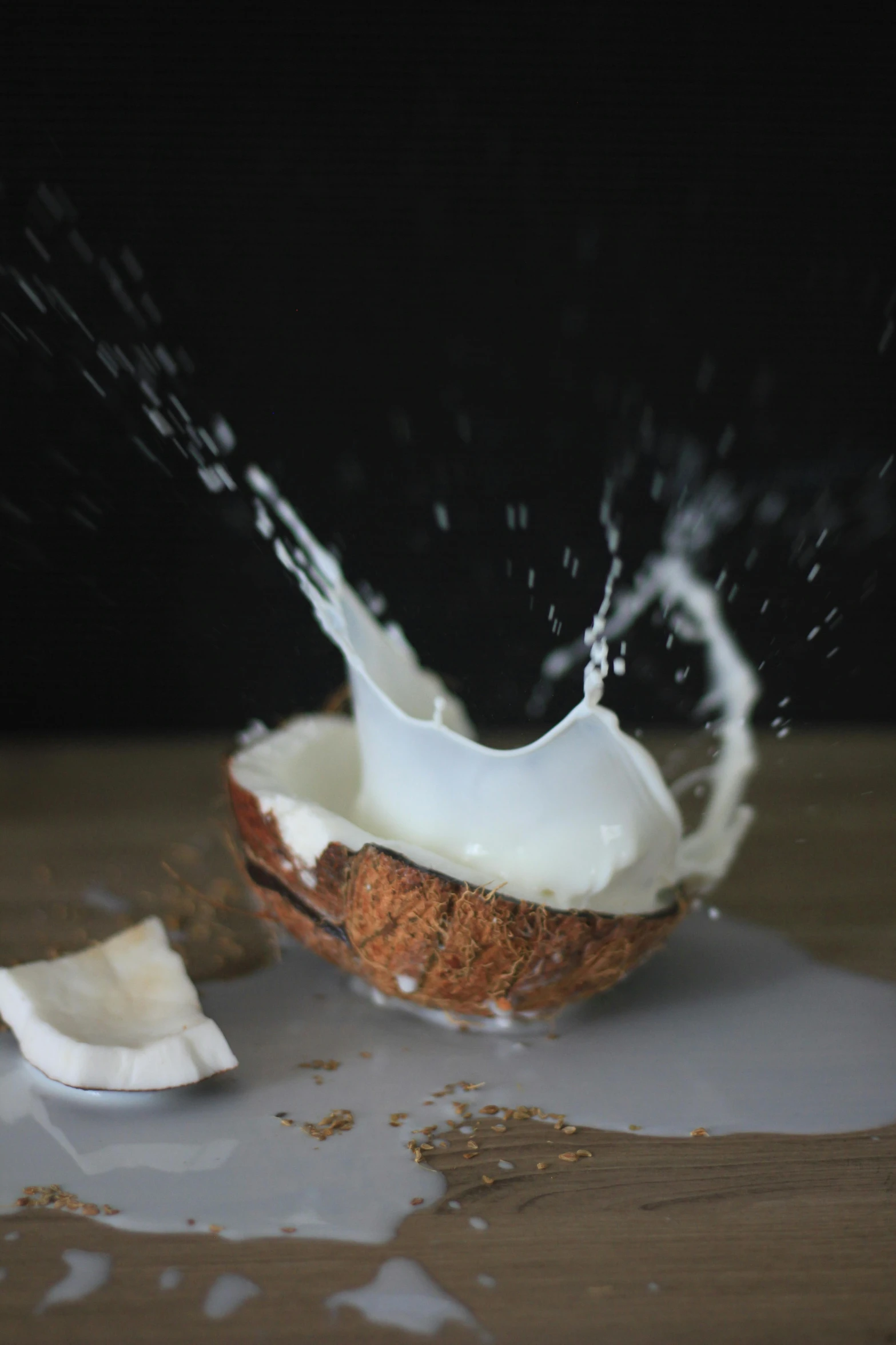 a broken coconut sitting on top of a wooden table, by Jessie Algie, unsplash, flowing milk, splashing, mozzarella, promo image