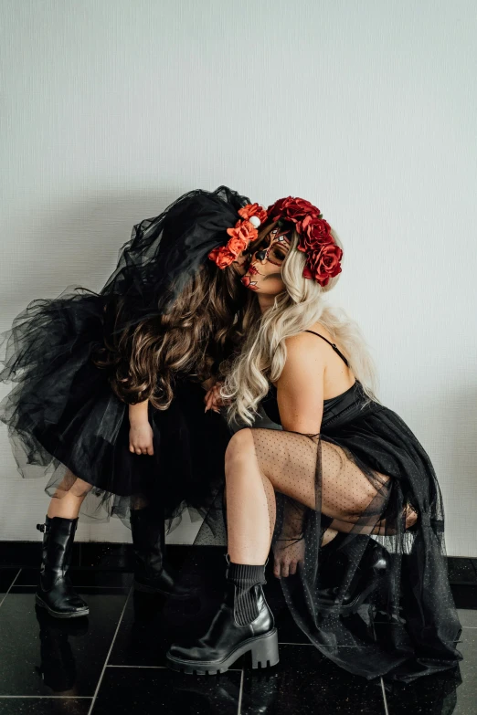 two women sitting next to each other on a tiled floor, unsplash contest winner, kitsch movement, black roses in hair, lesbian kiss, wearing black dress and hat, wearing a tutu