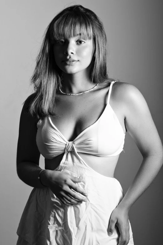 a woman in a white dress posing for a picture, a black and white photo, white bra, studio medium format photograph, portrait sophie mudd, chloe bennet